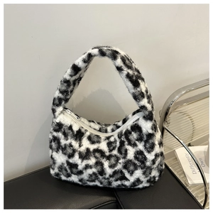 Close-up of leopard print faux fur shoulder bag with soft texture and white zipper closure