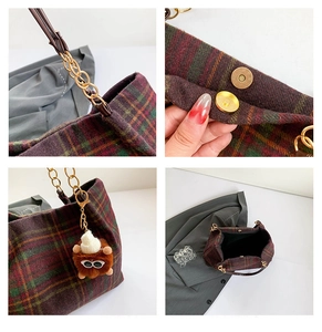 Detail view of vintage plaid tote bag with gold chain strap and plush pendant charm