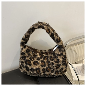 Detail of plush leopard print handbag showing soft faux fur texture and metal zipper