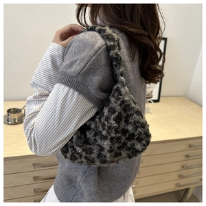 Detail of plush leopard print shoulder bag showing fuzzy texture and crescent shape