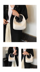 Three-way view of a white woven leather hobo bag paired with a minimalist black coat