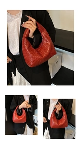 Close-up of red woven texture on a hobo handbag with a minimalist top zipper design