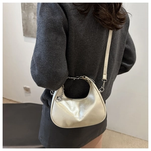 Detail of champagne gold hobo bag with silver chain and chic crossbody strap