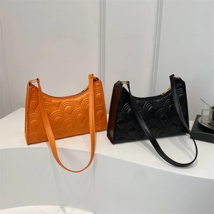 Minimalist wave-quilted shoulder bag for women in orange and black faux leather