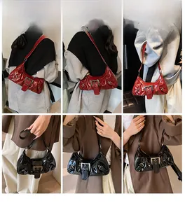 Detail view of red and black patent leather square bags with vintage buckles and pleats