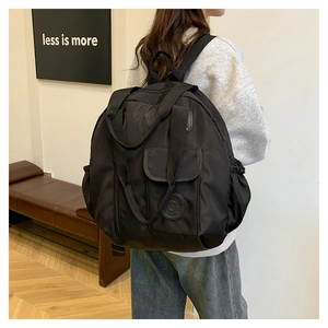 Versatile black waterproof nylon backpack for women with large capacity and hand-held handle
