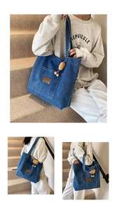 Detail of blue denim tote bag with brown leather patch and cute plush potato charm