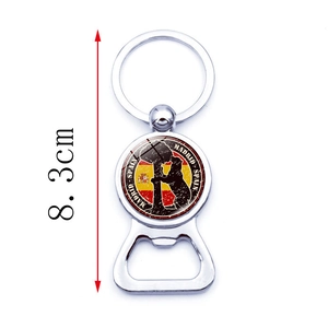 Detail of Madrid Spain bottle opener keychain with bear and strawberry tree emblem