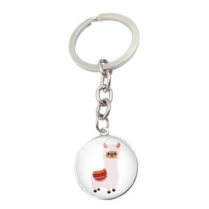 Macro view of a silver metal keychain featuring a cute cartoon alpaca illustration pendant