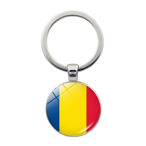 Macro shot of silver plated metal keychain with Romania flag under domed glass pendant