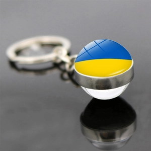 Detail of keychain featuring the Ukraine flag dome on a polished silver metal ring