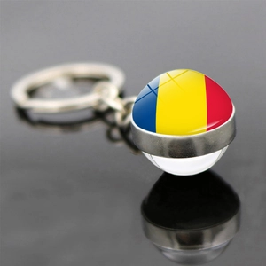 Close-up of a soccer keychain with Romania flag inside a transparent glass ball pendant