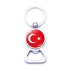 Close-up of a silver metal bottle opener keychain with circular Turkey flag emblem