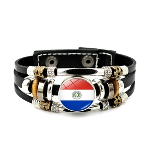 Detailed macro of vintage multi-layer leather bracelet with Paraguay flag emblem