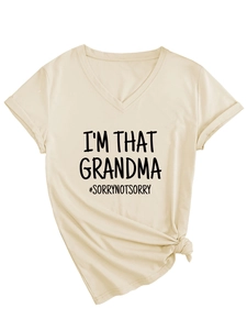 Close-up of I'M THAT GRANDMA print on a beige V-neck T-shirt with a stylish knotted hem