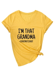 Detail of V-neck yellow t-shirt with rolled sleeves and a stylish bottom knot design