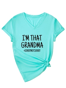 Detail of teal V-neck T-shirt with I'M THAT GRANDMA text in flat lay photography style