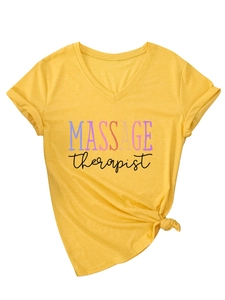Detail of V-neck yellow T-shirt showing colorful MASSAGE therapist print and side knot