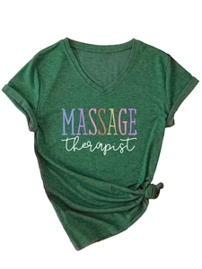 Detail of V-neck T-shirt showing knotted hem and rainbow MASSAGE therapist print