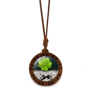 Vintage wood clover necklace with green four-leaf clover pendant on brown braided rope