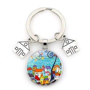 Detailed close-up of a starry night house keychain with colorful glass cabochon pendant