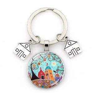 Detailed shot of creative metal keychain with abstract starry house and tree pendant