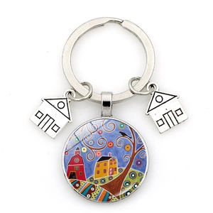 Macro shot of silver keychain featuring starry house illustration and glass tree charm