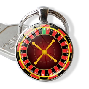 Macro detail of alloy casino roulette keychain with glass dome and red black dial