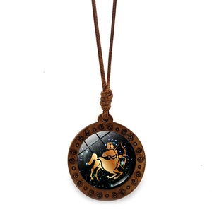 Detail view of Sagittarius zodiac necklace featuring a carved wood frame and glass dome