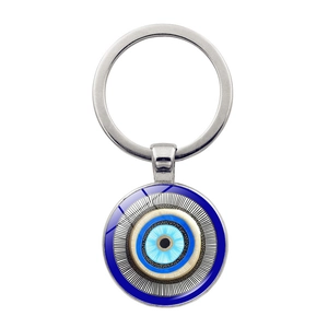 Close-up of Turkish Evil Eye keychain with blue protective amulet on white background