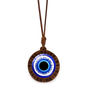 Turkish evil eye necklace with wooden pendant and blue glitter eye on white background