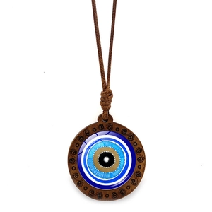 Ethnic blue evil eye wood necklace with spiral carving on a brown braided rope