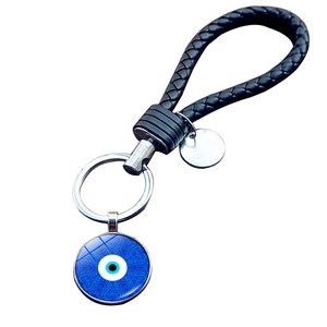 Close-up of evil eye keychain with blue mandala pattern and black braided leather strap