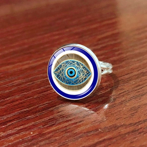 Adjustable silver evil eye ring with blue pupil and golden geometric textures