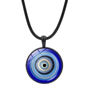 Macro view of blue Evil Eye glass pendant with black cord and intricate concentric circles