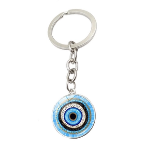 Detailed macro view of a round blue Evil Eye keychain pendant with intricate golden patterns