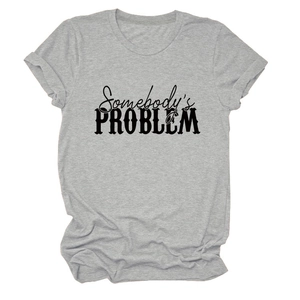 Gros plan du texte Somebody's Problem sur un T-shirt gris à manches courtes en coton