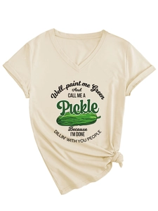 Detail of V-neck T-shirt showing green pickle print and humorous text on beige fabric
