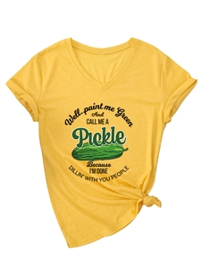 Detail of V-neck yellow T-shirt showing pickle graphic and side-knot hem detail