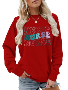 Close-up of red crewneck sweatshirt featuring colorful artistic NURSE graphic print