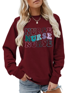 Close-up detail of burgundy nurse sweatshirt with stylized colorful letter print