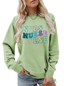 Close-up of pistachio green sweatshirt featuring wavy artistic NURSE typography design