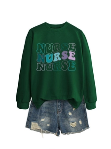 Detail of dark green sweatshirt with colorful NURSE print and distressed denim shorts