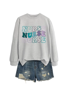 Detail of grey crewneck sweatshirt with colorful NURSE lettering and denim shorts