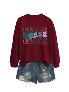 Detail of ribbed crewneck and colorful nurse typography on burgundy cotton sweatshirt