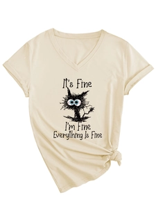 Detail of V-neck T-shirt showing knotted hem and humorous cat print on apricot fabric