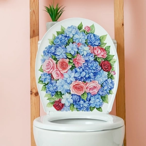 Blue hydrangea and pink rose floral wall decals applied on a white ceramic toilet lid
