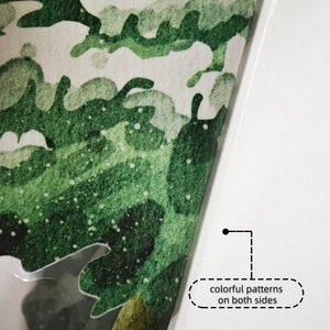 Detailed macro view showing the double-sided colorful plant patterns on soft textured fabric