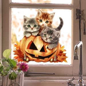 Detail of Halloween window clings featuring cute cats and pumpkins on a glass window