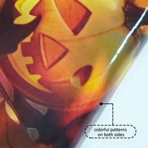 Macro shot of Halloween pumpkin sticker showing glossy finish and double-sided color printing